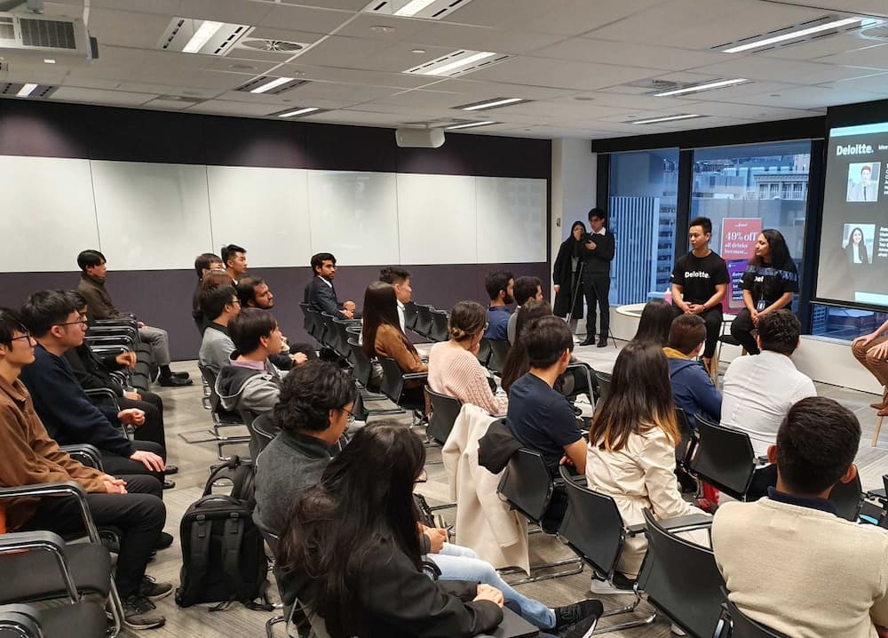 A photo of Brian Nguyen presenting at Deloitte